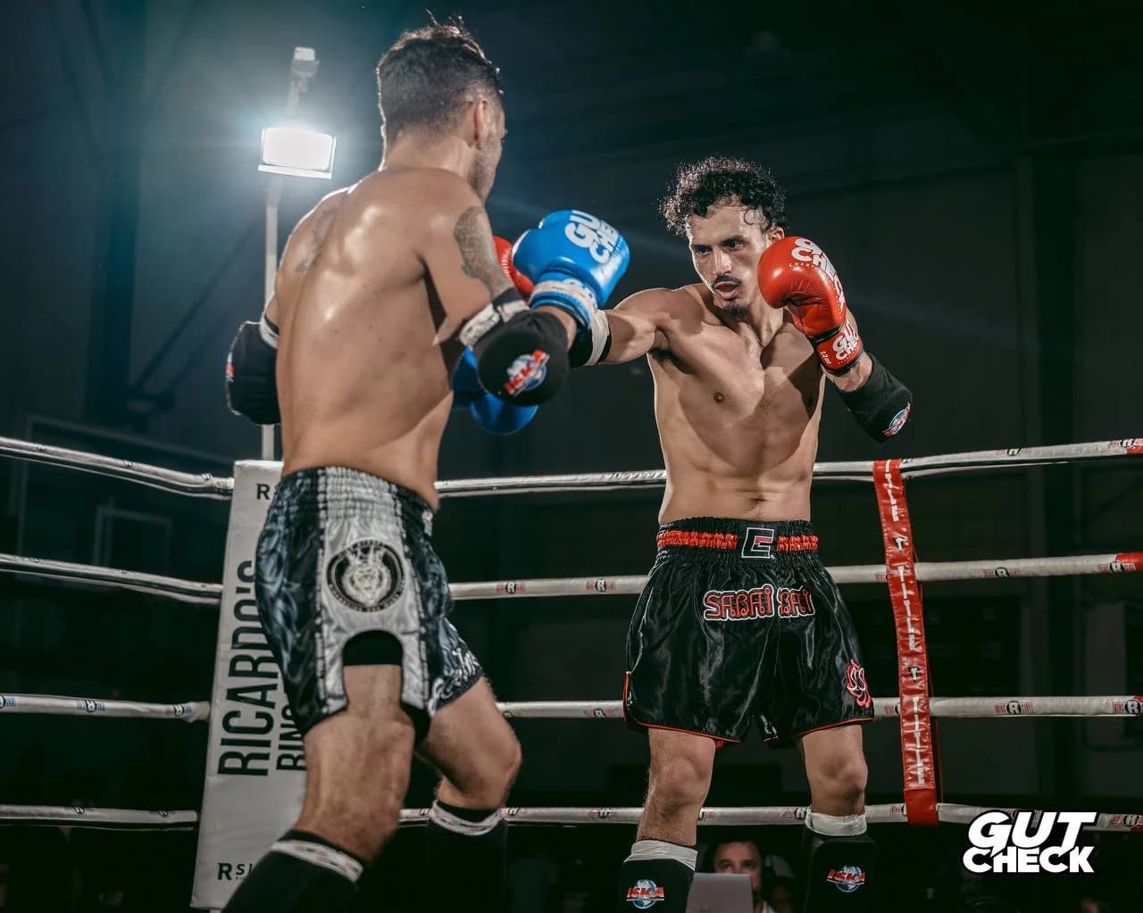 Two elite kickboxers trading punches in the ring near Philadelphia at Gut Check Championship Series.